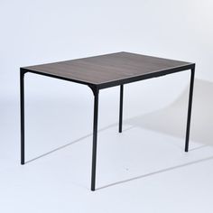 an empty table on a white background with no one around it or someone else to the side