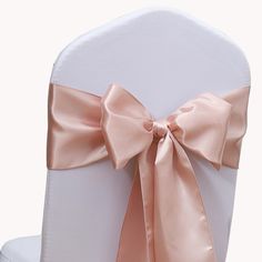 the back of a white chair with a pink bow on it's sashel