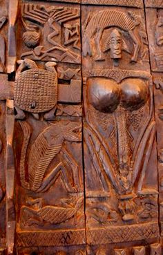 an intricately carved wooden door with carvings on it