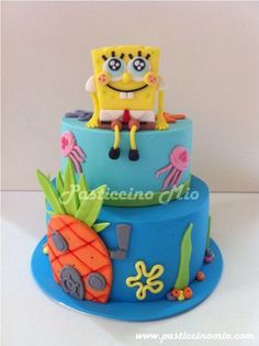 a spongebob themed cake with an octopus and pineapple on top, sitting on a blue plate