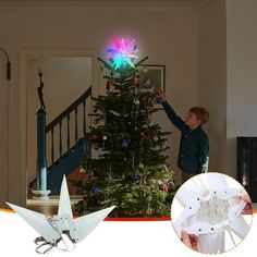 a boy decorating a christmas tree with lights