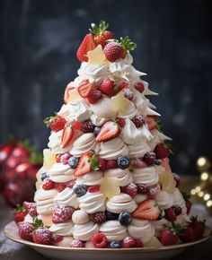 a small christmas tree made out of meringue and strawberries on a plate