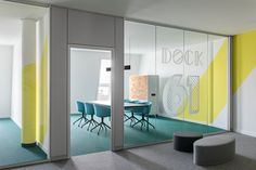 an office with yellow and blue accents on the walls