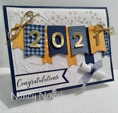 a congratulations card with ribbons and ribbon on the front, in blue and yellow colors