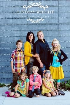 a family posing for a photo in front of a wall with the words lennesa wright on it