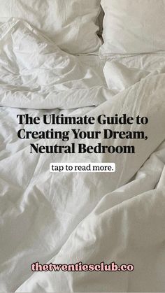 an unmade bed with white sheets and pillows