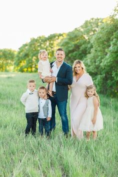 a family posing for a photo in a field