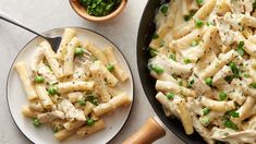 pasta with chicken and peas in a skillet next to a bowl of parsley