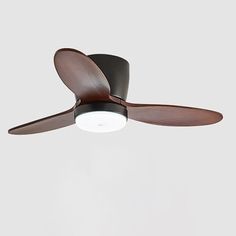 a ceiling fan that is brown and has two blades on the blades, with a light at the top