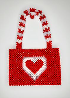 This beaded handbag is a true original! At approx. 9"X 10"X 2" It's the perfect size for your phone, keys and cards.  The 20" strap is great for over the shoulder and nestles high and securely.  Also a wonderful length to carry by handle down by the hip.  Made of acrylic beads, so its super easy to handwash when needed.  Made by Lora Rolling.  Ships to US (only) via USPS.  Arrives within 7 days! All sales are final. Questions? Text 214-872-0062 Beaded Tote Shoulder Bag, Everyday Beaded Rectangular Shoulder Bag, Everyday Beaded Tote Shoulder Bag, Everyday Beaded Shoulder Bag, Everyday Red Beaded Bags, Square Beaded Bag For Everyday Use, Red Beaded Rectangular Shoulder Bag, Valentine's Day Rectangular Shoulder Bag For Daily Use, Valentine's Day Gift Beaded Bag