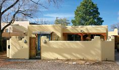 an adobe - style house is shown in the desert