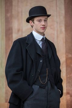 a young man in a top hat and coat