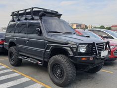 an suv parked in a parking lot next to other cars