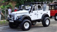 two jeeps parked next to each other on the street