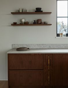 a kitchen with wooden cabinets and white counter tops