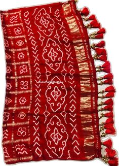 Red Pre-draped Saree With Traditional Patterns For Navratri, Traditional Red Pre-draped Saree With Zari Weaving, Traditional Red Pre-draped Saree For Festive Occasions, Festive Red Pre-draped Saree With Pallu, Red Pre-draped Saree With Pallu For Eid, Red Sharara With Motifs For Traditional Ceremonies, Festive Red Choli With Motifs, Red Bandhani Print Dupatta For Festive Occasions, Red Bandhani Traditional Wear