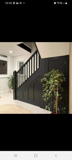 the stairs in this house are black and white with wood balconies on them