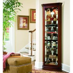 Pulaski Furniture Victorian Cherry Corner Curio, 21001-p. In just 16  of wall space, our curio allows you to maximize space and bring art and light into a room. That s smart design. The traditional curio features classic moldings, canted corners, and incised glass. It is built in select hardwood solids and veneers features with a rich Victorian Cherry finish. Our curio includes a lighted interior, mirror back, and adjustable glass shelves with plate grooves.Pulaski Furniture Curios Collection SKU: 21001-p Bedroom Furniture Redo, Corner Curio Cabinet, Corner Curio, Curio Cabinets, Furnitur Ruang Keluarga, Living Room Corner, Glass Cabinets Display, Pulaski Furniture, Room Corner