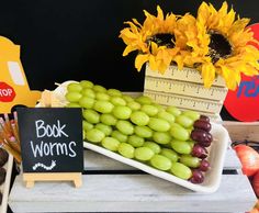 grapes and sunflowers are on display at a book worms party