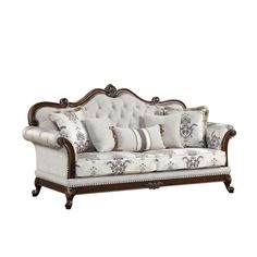 an ornately decorated couch with pillows on it's back and armrests