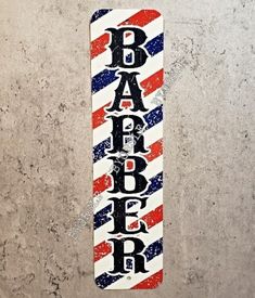 a red, white and blue striped skateboard with the word barber on it's side