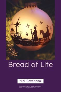 a christmas ornament with the words bread of life written in white and purple