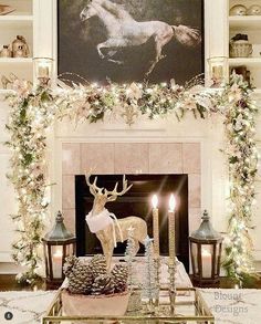 a living room decorated for christmas with candles and deer figurines on the mantel