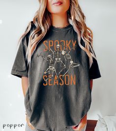 Cute Spooky Season T-shirt ,Halloween Skeleton Dancing Shirt, Womens Halloween Tshirt, Cute Fall Tee, Gift For Halloween, Retro Halloween 👉 ABOUT  Dancing Skeleton Comfort Colors® 1717 Shirt - 100% Airlume combed and ringspun cotton - Soft cotton and quality print make users fall in love with it over and over again. - These t-shirts have-ribbed knit collars to bolster shaping. - Printed and shipped from the USA CARE INSTRUCTIONS - Wash inside out with like colors. - Tumble dry or hang to dry. - Spooky Skull Print Top For Fall, Spooky Skull Print Fall Top, Spooky Skull Print Tops For Fall, Fall Skull Print Cotton T-shirt, Fall Cotton T-shirt With Skull Print, Halloween Graphic Tee T-shirt, Fall Crew Neck Shirt With Skull Print, Spooky Halloween T-shirt With Graphic Print, Spooky Black T-shirt For Fall