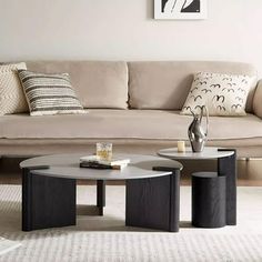 a living room filled with furniture and a coffee table on top of a rug in front of a couch