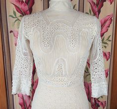 "Another Beautiful Antique 1900's Cutwork-Eyelet-Net-Bobbin-Filet-Lace and Pintucked Edwardian Gown! Need more photos? I've got them. Just ask! This antique Edwardian gown is gorgeous! This one-of-a-kind gown has been hand made and tailored with rows of embroidered eyelet lawn, netting with tiny pintucks, filet lace and tiny fabric covered buttons. This classic Edwardian silhouette has a fitted bust and fitted waist, and a sweeping hem. The 2\" high neckline is accented with additional tiny net Fitted Lace Victorian Dress For Vintage Events, Cream Fitted Victorian Evening Dress, Fitted Cream Victorian Evening Dress, Fitted Cream Victorian Dress For Evening, Fitted Lace Victorian Dress With Historical Design, Fitted Victorian Dress In Vintage White For Formal Occasions, Fitted Vintage White Victorian Dress For Formal Occasions, Formal Fitted Victorian Dress In Vintage White, Formal Fitted Vintage White Victorian Dress