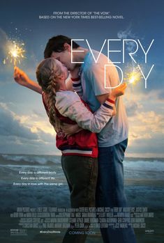 a man and woman kissing while holding sparklers in front of the ocean with clouds