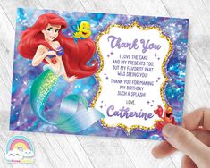 the little mermaid birthday party card is being held up by someone's hand,