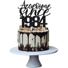 there is a cake that has been decorated with the number 1994 on it and chocolate drips