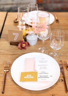 a table set with place settings, silverware and napkins for an elegant dinner