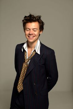 a man in a suit and tie smiling