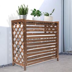 a wooden planter sitting on top of a cement floor next to a white wall