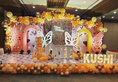 a decorated stage with balloons and decorations for a birthday party in the shape of butterflies