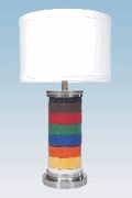 a multicolored table lamp with a white shade on the bottom and a silver base