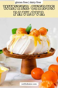 A pavlova served on a wooden cake stand and topped with whipped cream, fresh citrus and clementine curd. Marshmallow Meringue, Gluten Free Dessert, Winter Dessert, Christmas Dessert Table, Christmas Dessert, Holiday Entertaining, Pavlova, Meringue, Dessert Table