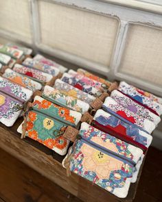 many small purses are lined up on a table