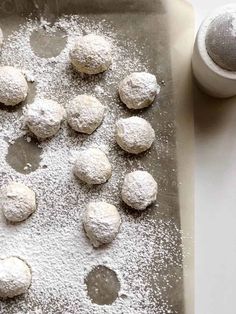 doughnuts on a baking sheet with powdered sugar