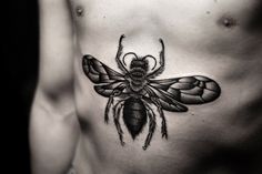 a black and white photo of a bee on the chest