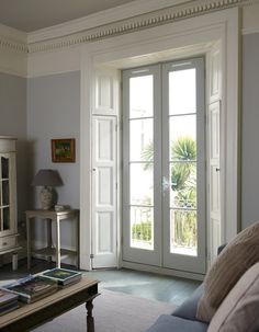 a living room filled with furniture and french doors