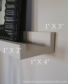 the shelf is made out of wood and has two brackets on each side, along with one