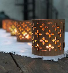 three lit candles sitting on top of a wooden table