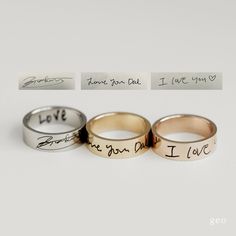 three wedding rings with handwriting on them, one has a love note and the other has two