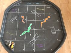 a chalk board with ladders and snakes drawn on it