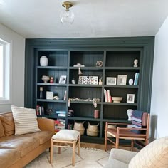 a living room filled with furniture and bookshelves