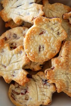 several small pies are stacked on top of each other in a white bowl with a brown border around the edges