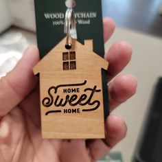 a house shaped keychain with the words home sweet home on it's front